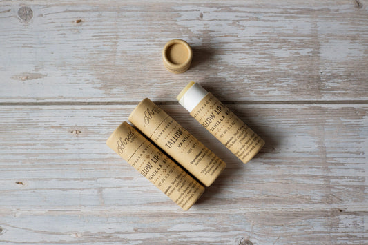 Three cardboard tubes with labels on a wooden surface