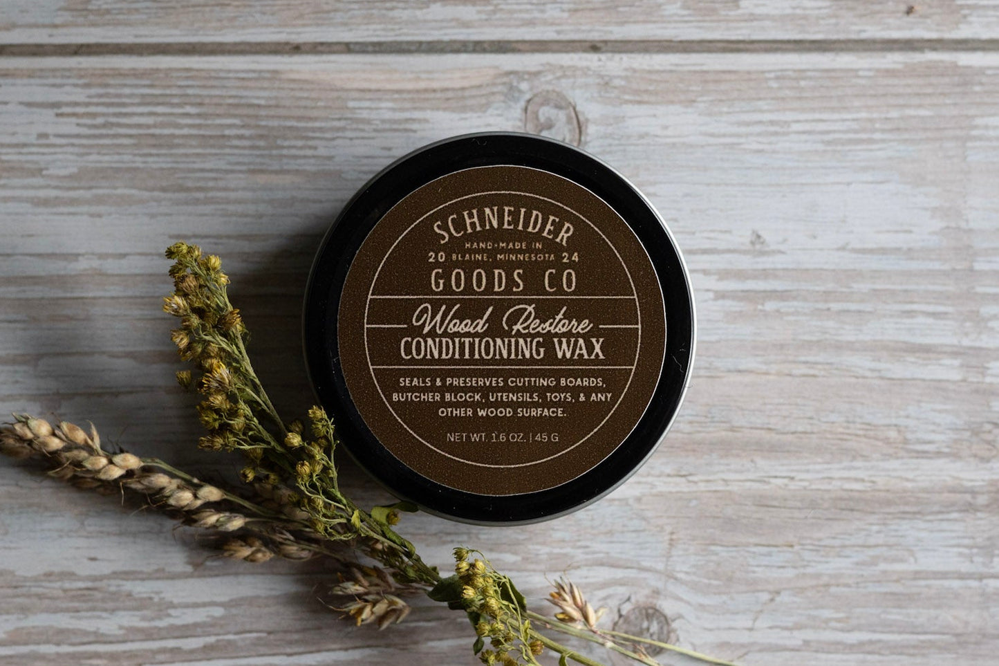 schneider goods co wood restore conditioning wax on wooden background