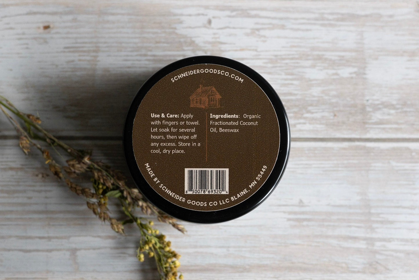 back of schneider goods co wood wax tin on wooden background