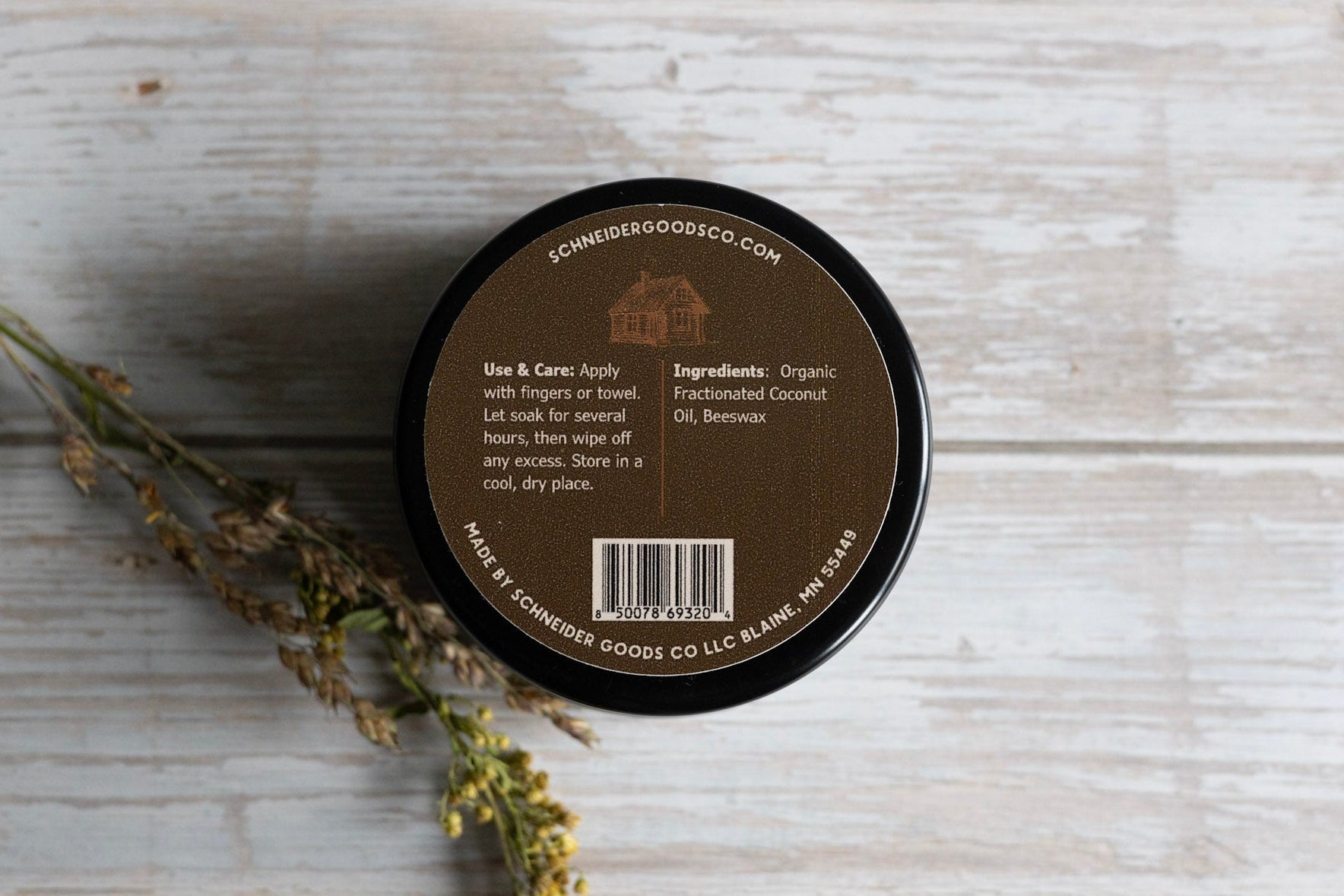 back of schneider goods co wood wax tin on wooden background