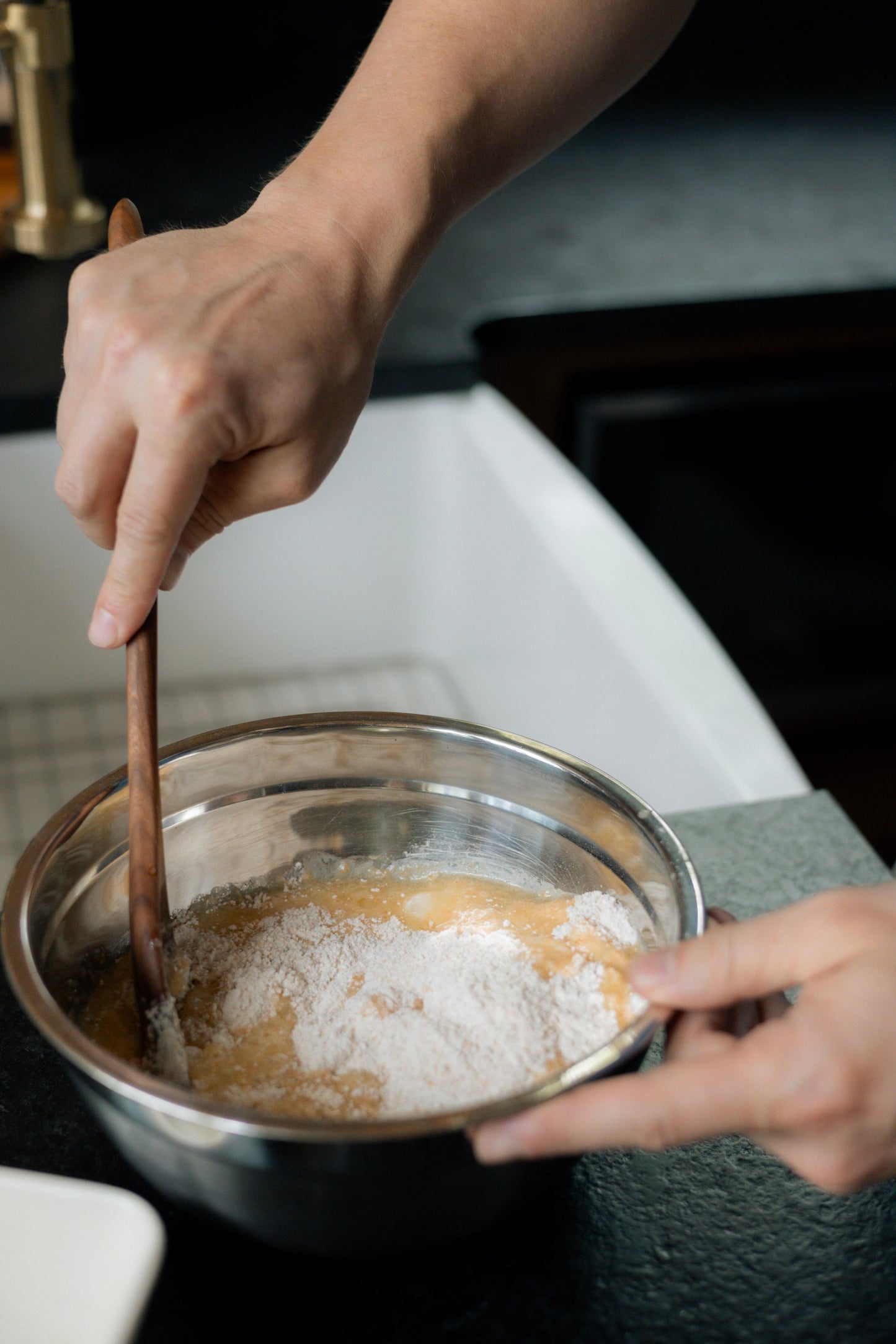 Cherry wood spoon stirring muffin mix